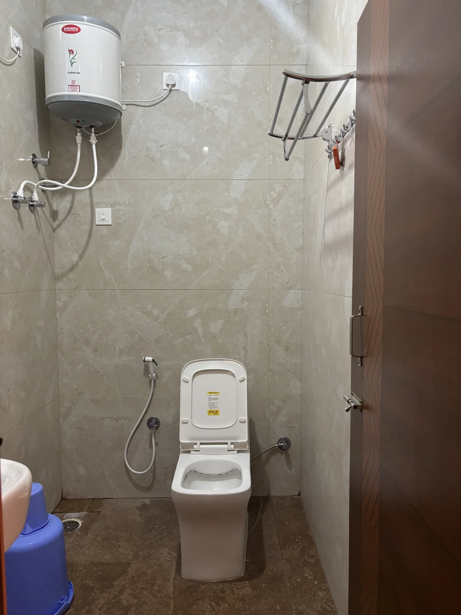 Attached modern bathroom with water heater geyser at Sri Durga Comforts