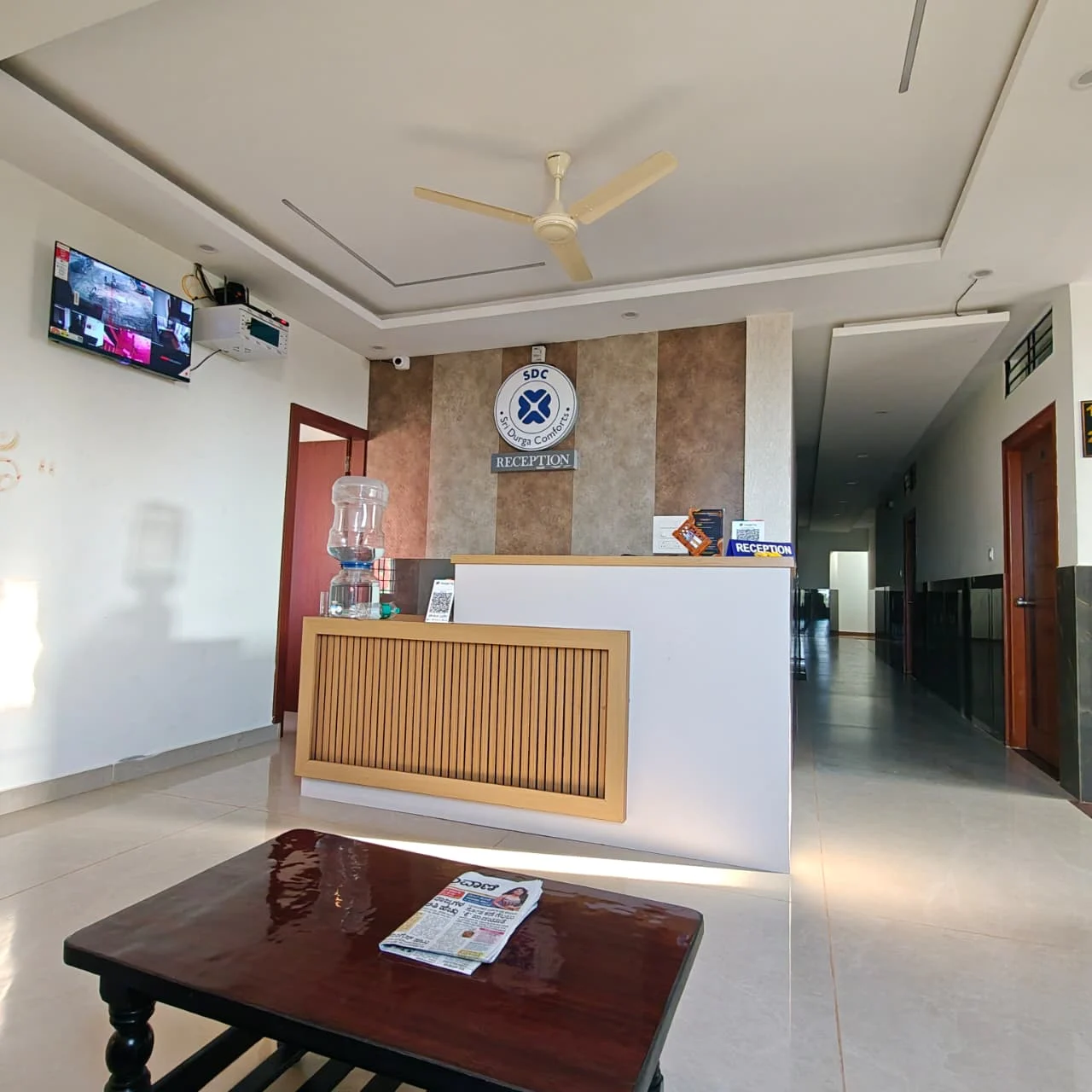Daytime perspective of the reception counter and guest hallway